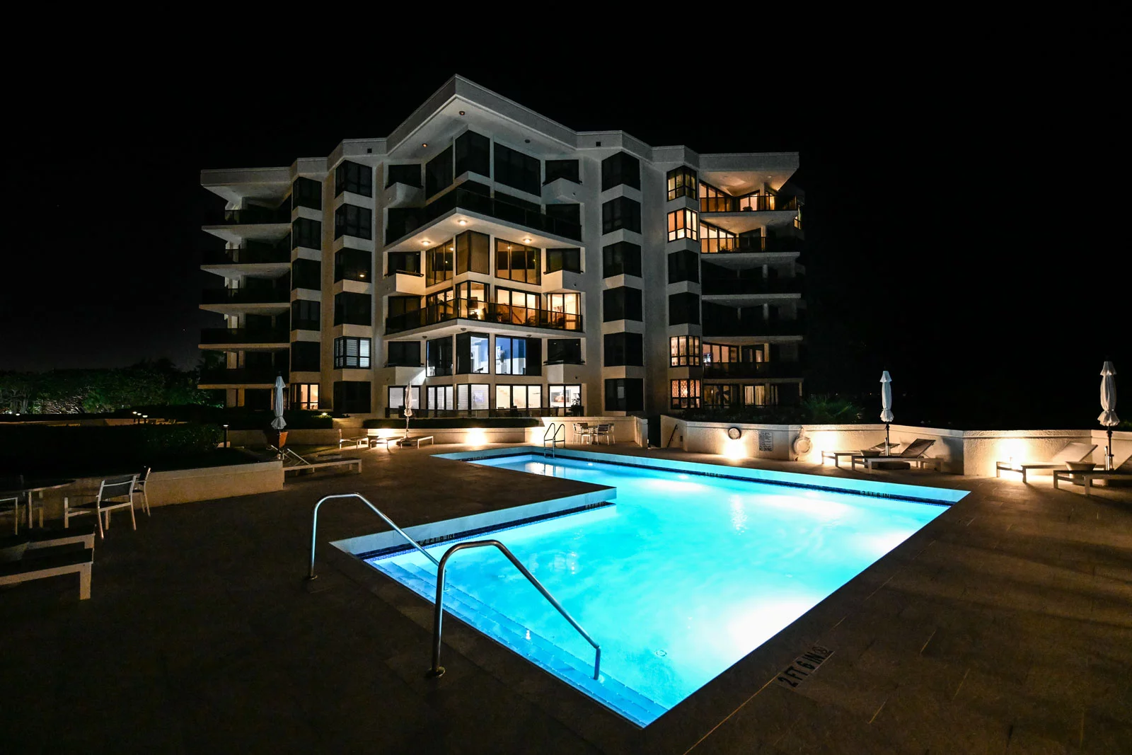 Oasis Palm Beach pool area with evening lighting